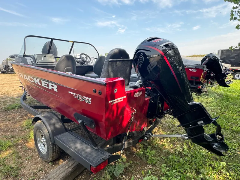 Slide: The Image of 2025 Tracker Pro Guide V-175 Combo boat with outboard motor, parked on a trailer. - 4