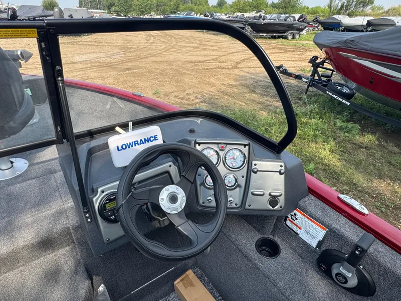 Slide: The Image of 2025 Tracker Pro Guide V-175 Combo boat dashboard with steering wheel and gauges. - 8