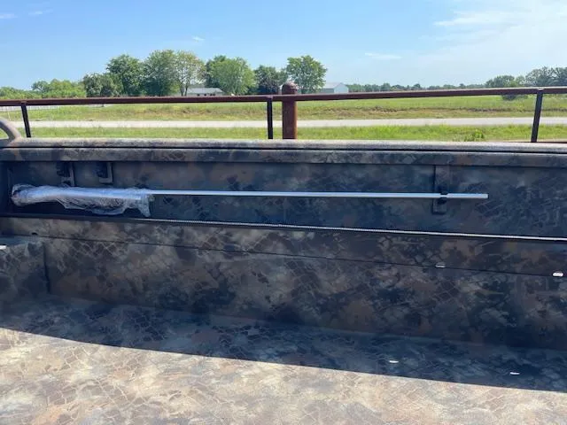 Slide: The Image of Boat interior of 2025 Excel Eclipse with camouflage design, featuring a rod holder. - 6