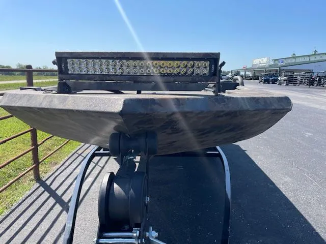 Slide: The Image of 2025 Excel Eclipse boat with LED light bar on trailer, parked outdoors. - 7