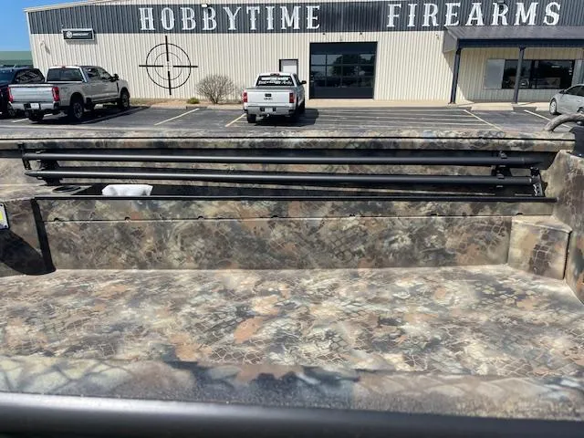 Slide: The Image of Camo-patterned Excel Eclipse 2025 boat parked outside Hobbytime Firearms store. - 8