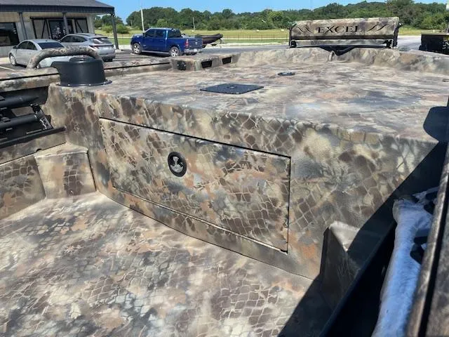 Slide: The Image of 2025 Excel Eclipse boat with camouflage pattern, parked outdoors. - 9
