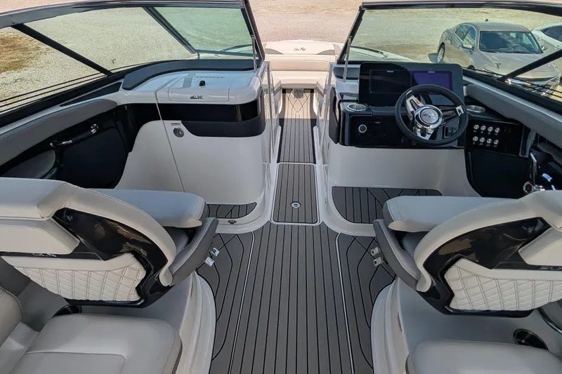 Slide: The Image of 2025 Sea Ray SLX 260 Surf boat interior with modern dashboard and seating. - 10