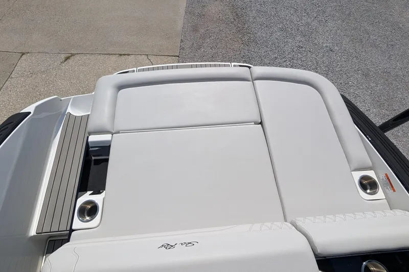 Slide: The Image of 2025 Sea Ray SLX 260 Surf boat with sleek white seating and cup holders. - 16