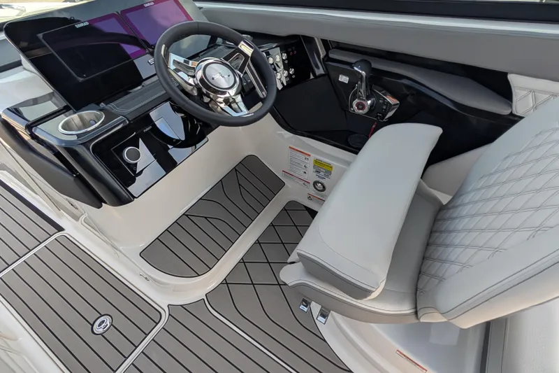 Slide: The Image of 2025 Sea Ray SLX 260 Surf boat cockpit with modern steering and controls. - 18