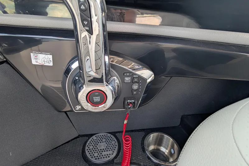 Slide: The Image of 2025 Sea Ray SLX 260 Surf boat control panel with start/stop button and throttle lever. - 19