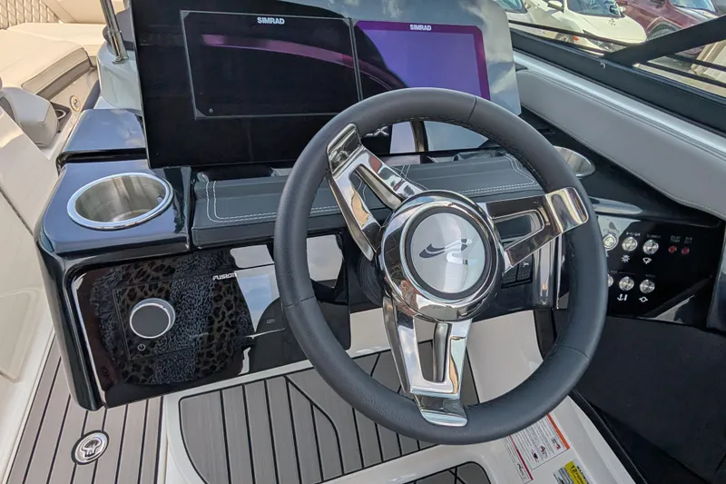 Slide: The Image of 2025 Sea Ray SLX 260 Surf boat dashboard with steering wheel and digital displays. - 22