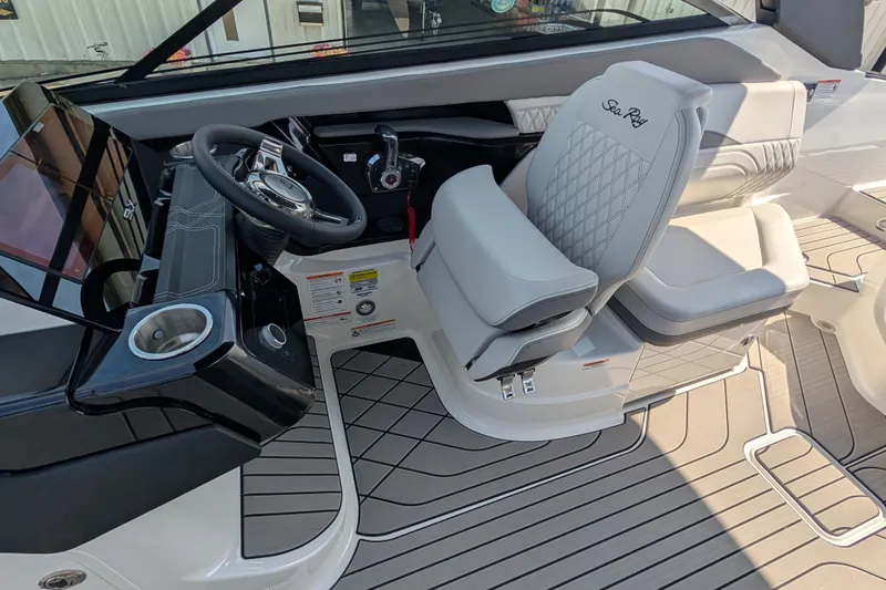 Slide: The Image of 2025 Sea Ray SLX 260 Surf boat interior with steering wheel and luxurious seating. - 24