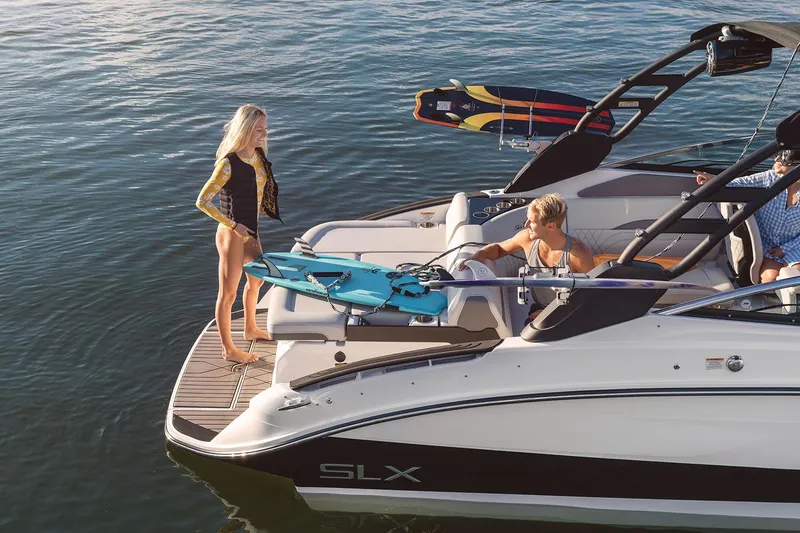 Slide: The Image of Manufacturer Provided Image: 2025 Sea Ray SLX 260 Surf boat with people enjoying water activities. - 31