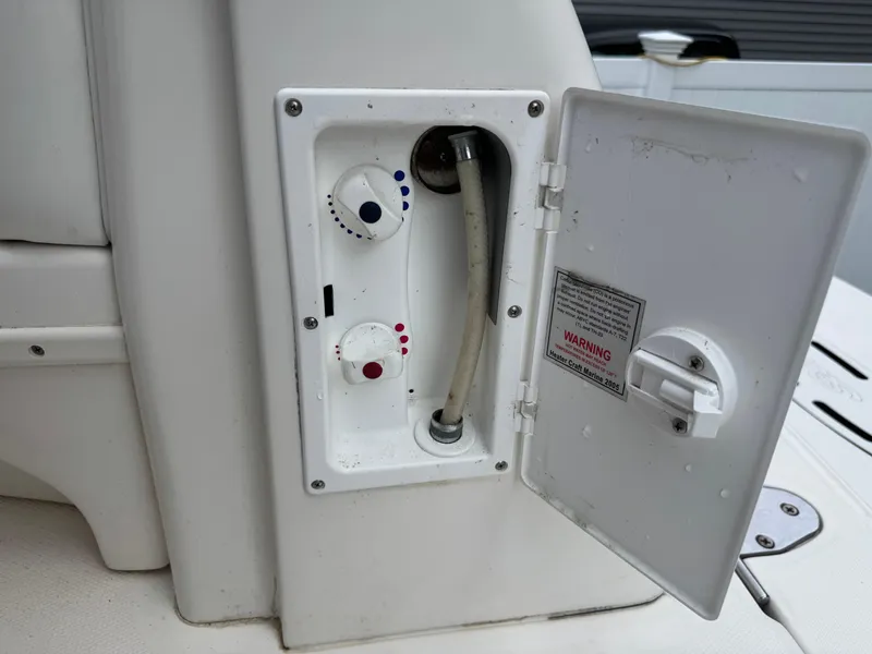 Slide: The Image of Control panel on a 2003 Sea Ray 320 Sundancer boat with open access door. - 28