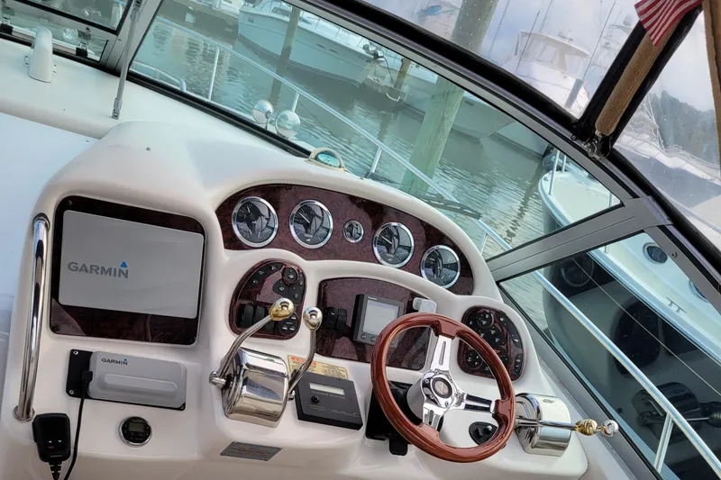 Slide: The Image of Cockpit of 2003 Sea Ray 320 Sundancer with Garmin navigation system and wooden steering wheel. - 3