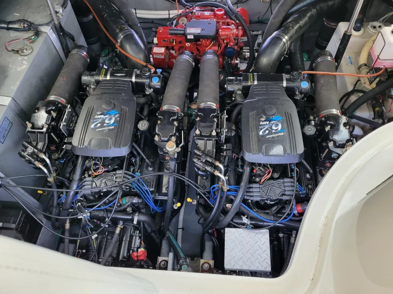 Slide: The Image of Engine compartment of a 2003 Sea Ray 320 Sundancer boat, featuring dual engines. - 30
