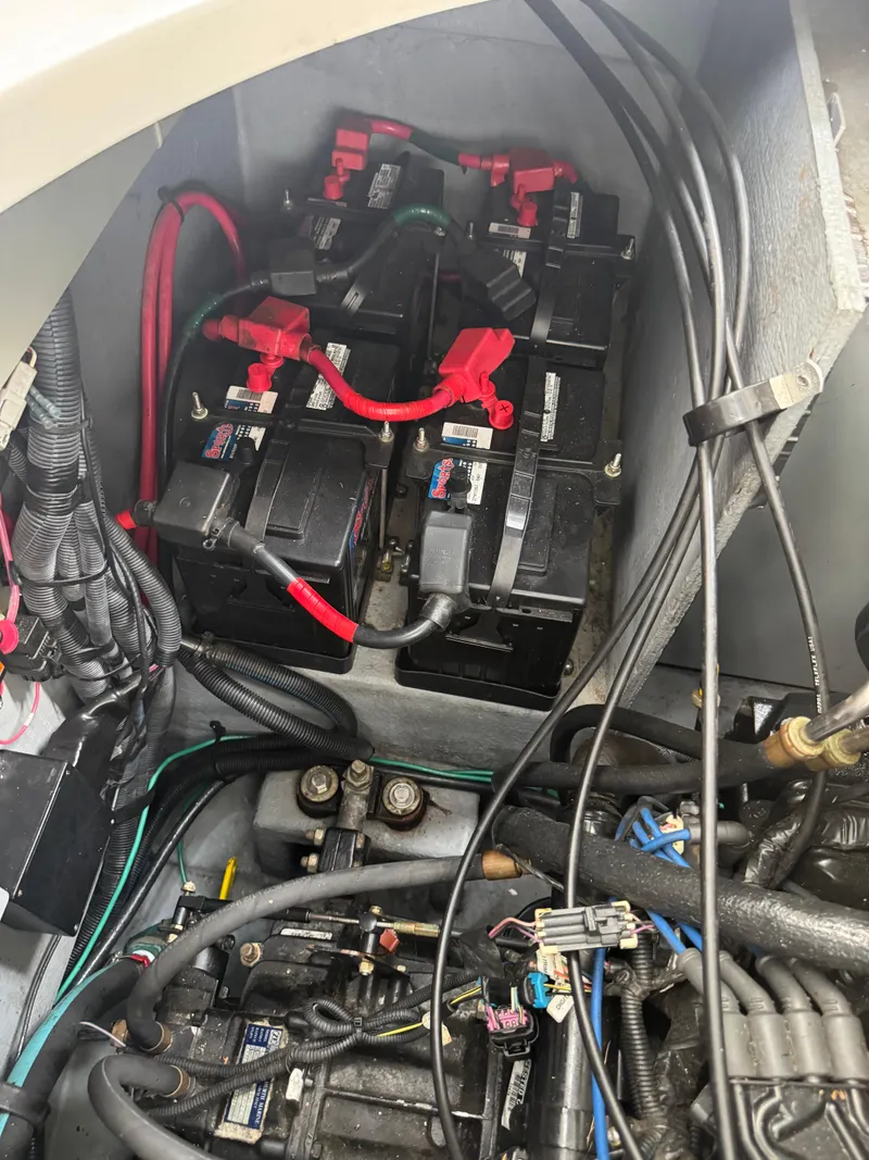Slide: The Image of Engine compartment of a 2003 Sea Ray 320 Sundancer with multiple batteries and wiring. - 31