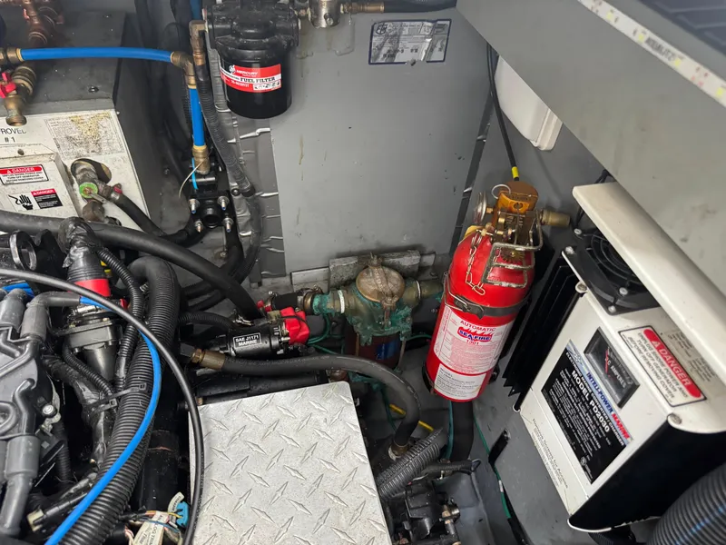 Slide: The Image of Engine compartment of a 2003 Sea Ray 320 Sundancer with fire extinguisher and fuel filter. - 33