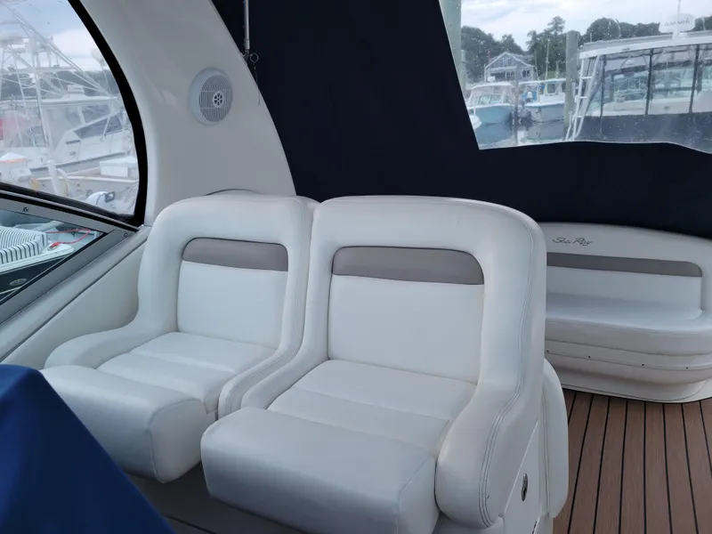 Slide: The Image of Interior of 2003 Sea Ray 320 Sundancer with white seating and wood flooring. - 4