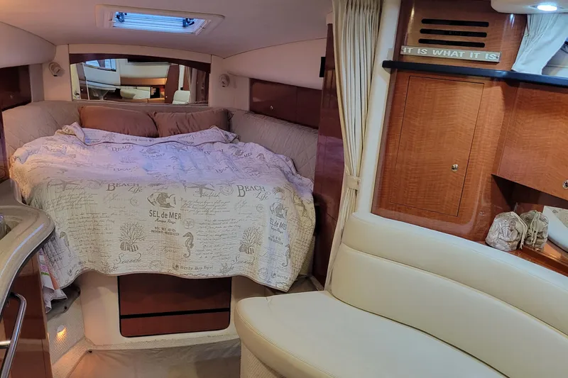 Slide: The Image of Interior of 2003 Sea Ray 320 Sundancer with cozy bed and wooden cabinetry. - 7