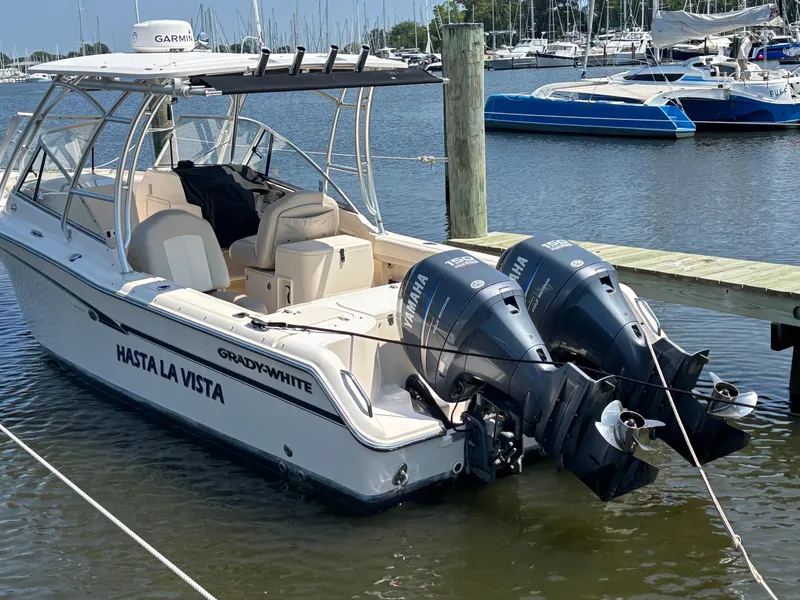 Slide: The Image of 2011 Grady-White Freedom 275 boat docked with twin Yamaha engines. - 1