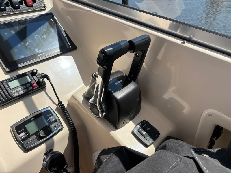 Slide: The Image of Control panel of a 2011 Grady-White Freedom 275 boat with throttle and navigation equipment. - 10