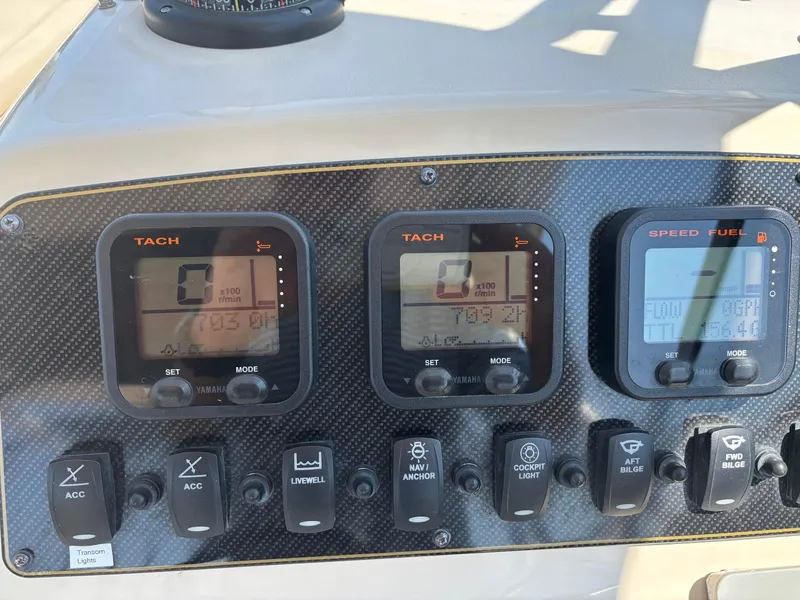 Slide: The Image of Dashboard of a 2011 Grady-White Freedom 275 boat with tachometer and control switches. - 16
