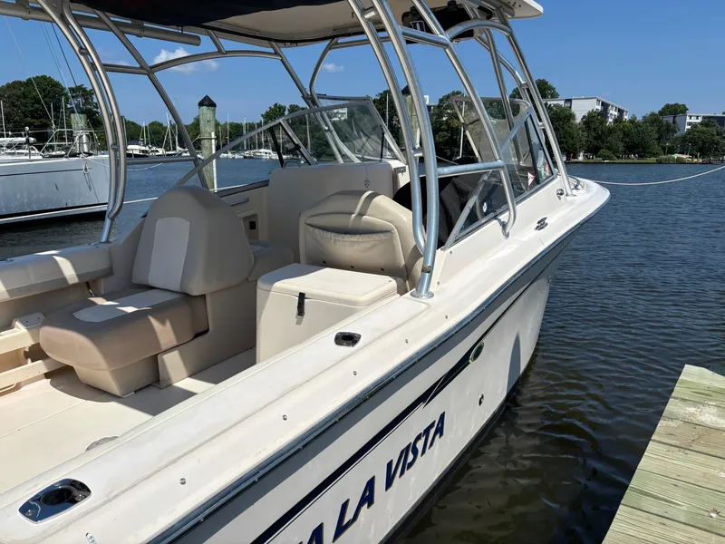 Slide: The Image of 2011 Grady-White Freedom 275 boat docked by the water on a sunny day. - 2