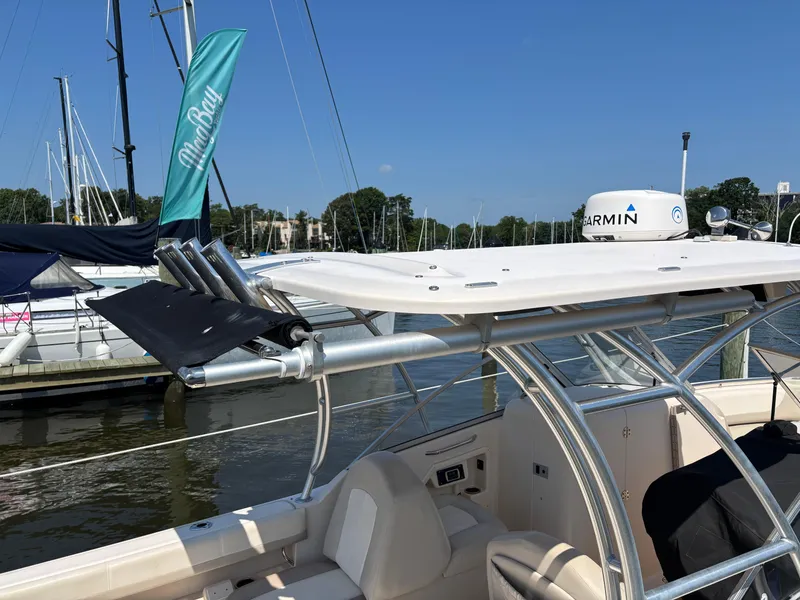 Slide: The Image of 2011 Grady-White Freedom 275 boat docked, featuring Garmin equipment and sleek design. - 4
