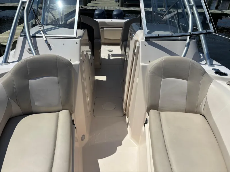 Slide: The Image of 2011 Grady-White Freedom 275 boat interior with beige seating and dual consoles. - 5
