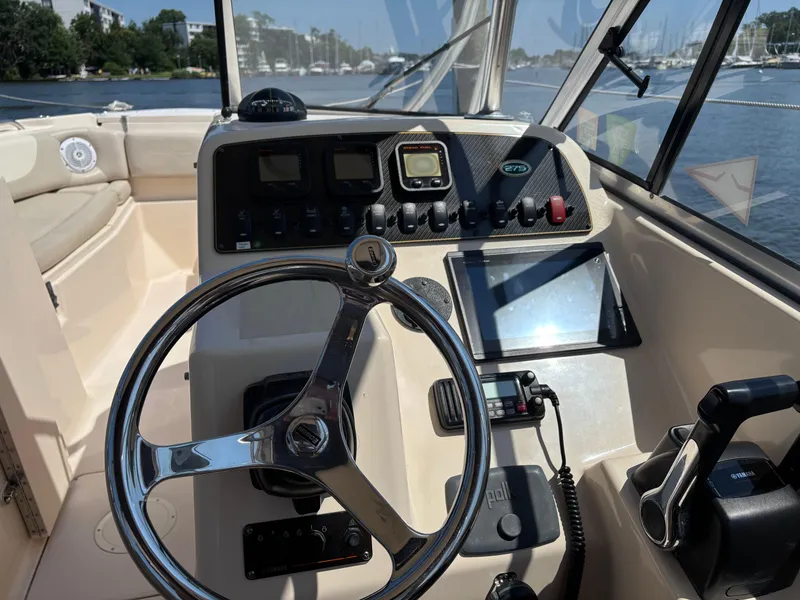 Slide: The Image of 2011 Grady-White Freedom 275 boat cockpit with steering wheel and control panel. - 7