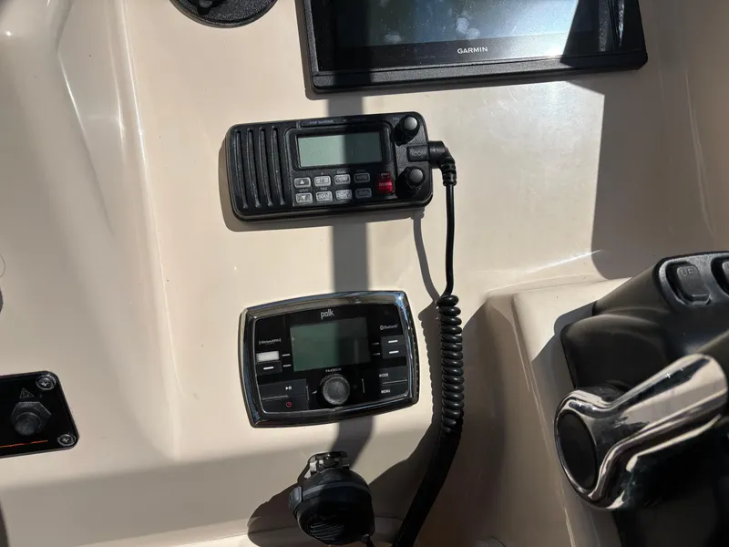 Slide: The Image of Control panel of a 2011 Grady-White Freedom 275 boat with Garmin and Polk devices. - 9