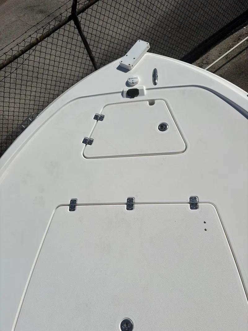 Slide: The Image of 2023 Caymas 28 HB boat deck with storage compartments and hardware. - 13