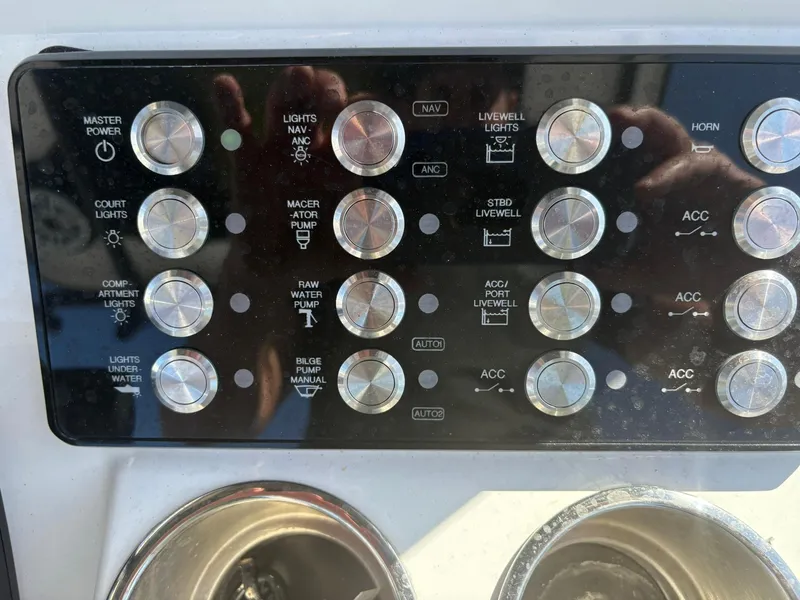 Slide: The Image of Control panel of 2023 Caymas 28 HB boat with various switches and dials. - 15