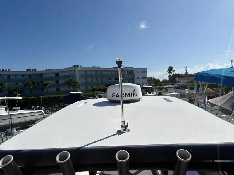 Slide: The Image of 2023 Caymas 28 HB boat with Garmin equipment, docked under clear blue sky. - 16