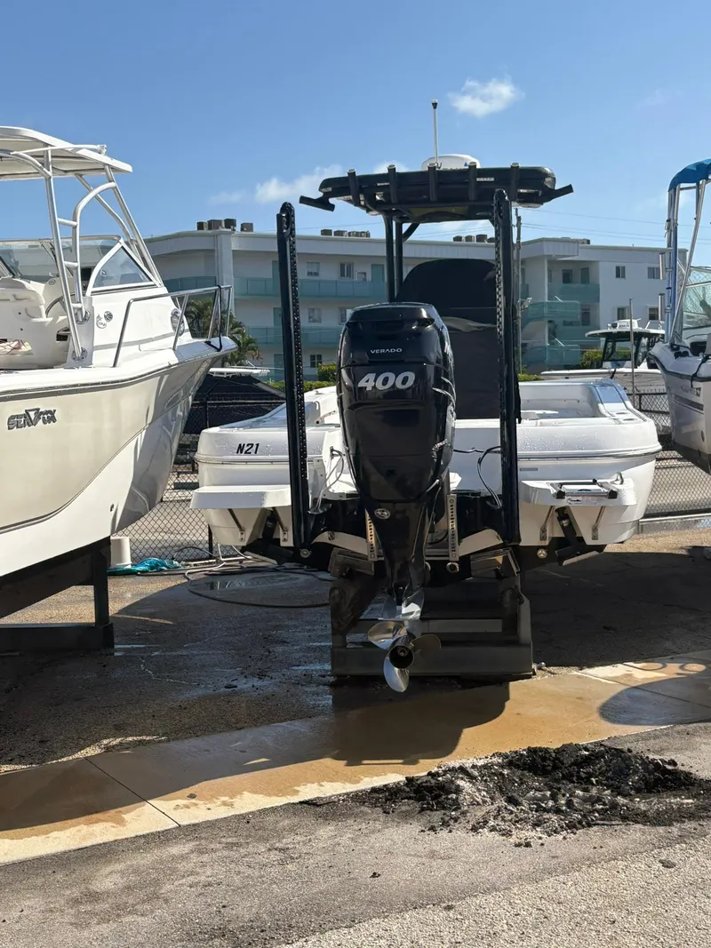 Slide: The Image of 2023 Caymas 28 HB boat with 400 horsepower engine, docked in a marina. - 3