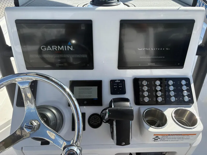 Slide: The Image of Control panel of 2023 Caymas 28 HB boat with Garmin displays and steering wheel. - 4