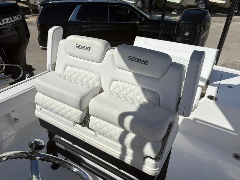 Slide: The Image of 2023 Caymas 28 HB boat with luxurious white seating and steering wheel. - 5