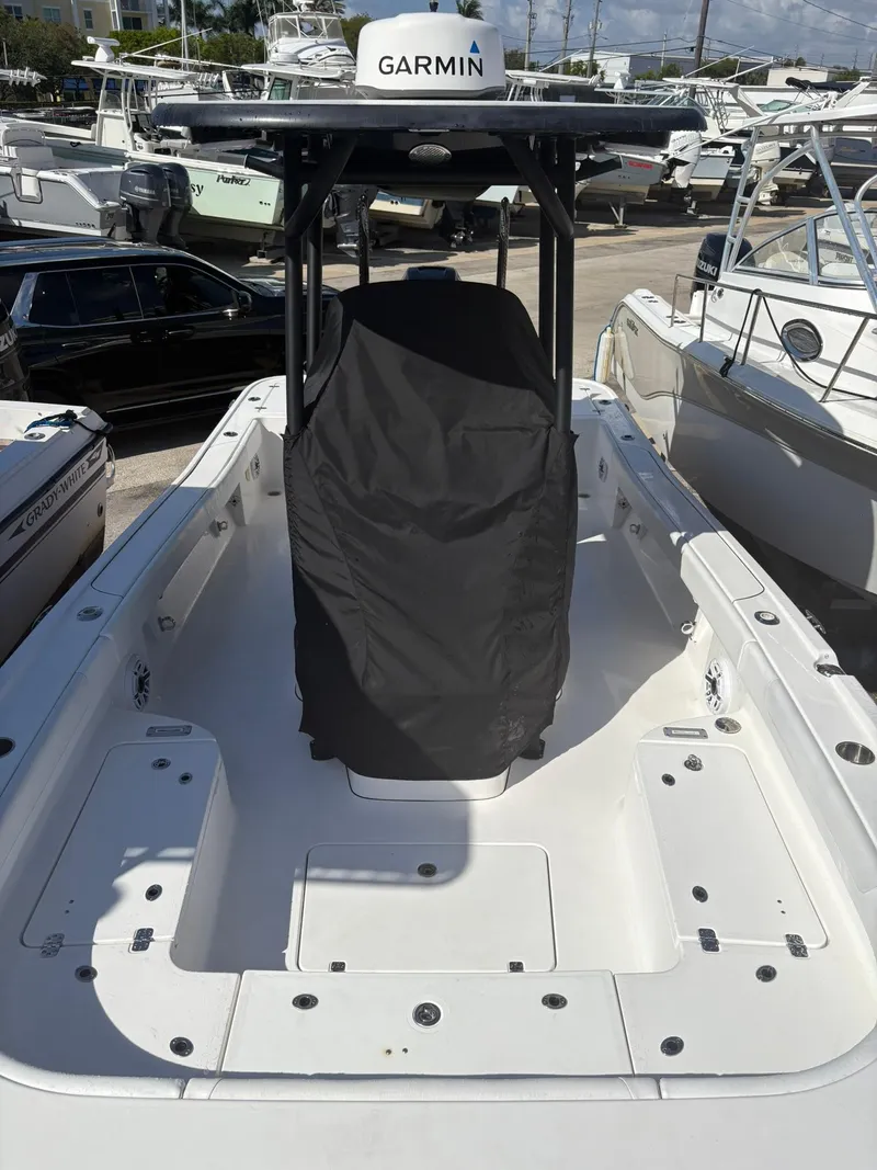 Slide: The Image of 2023 Caymas 28 HB boat with Garmin equipment, docked among other vessels. - 6