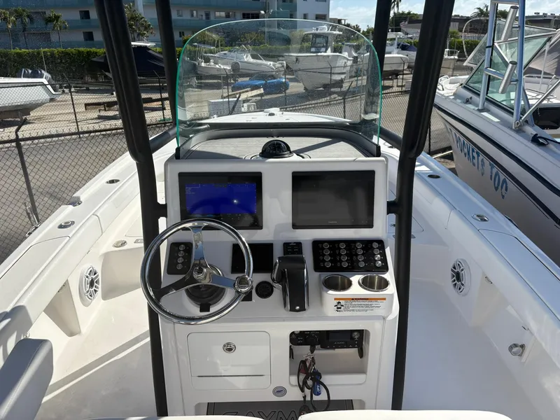 Slide: The Image of 2023 Caymas 28 HB boat dashboard with steering wheel and navigation screens. - 8