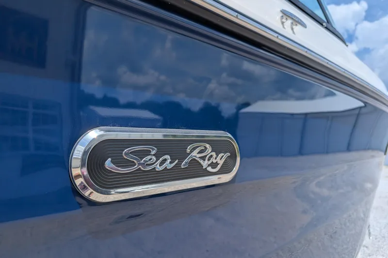 Slide: The Image of 2025 Sea Ray SDX 250 boat emblem on sleek blue hull. - 10
