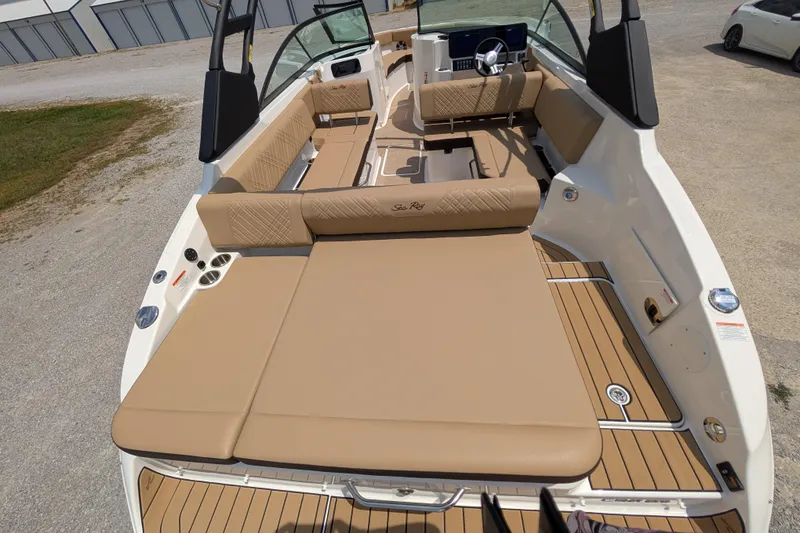 Slide: The Image of 2025 Sea Ray SDX 250 boat interior with tan seating and modern dashboard. - 11