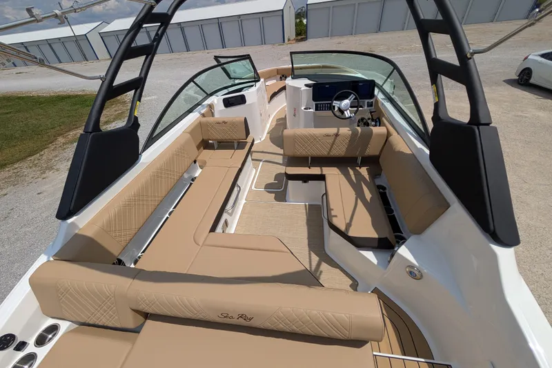 Slide: The Image of 2025 Sea Ray SDX 250 boat interior with tan seating and modern dashboard. - 12