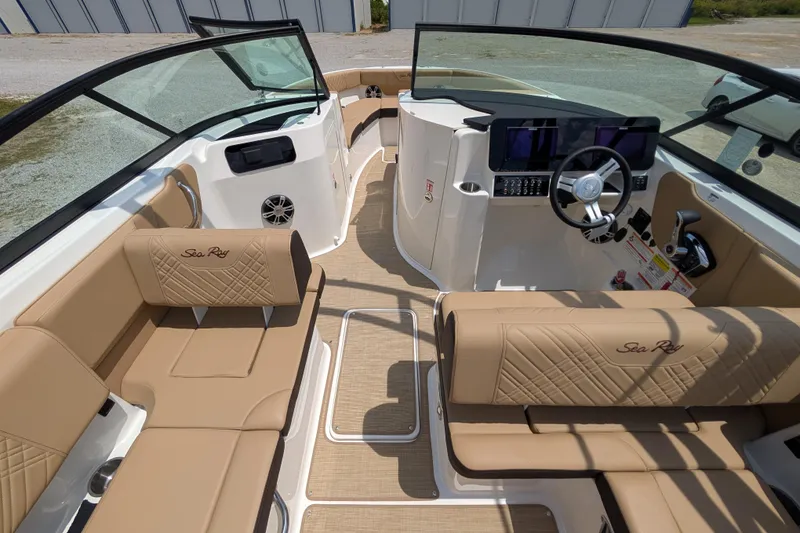 Slide: The Image of 2025 Sea Ray SDX 250 boat interior with tan seating and modern dashboard. - 13