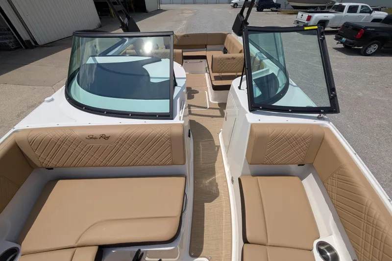 Slide: The Image of 2025 Sea Ray SDX 250 boat interior with tan seating and open windshield. - 16