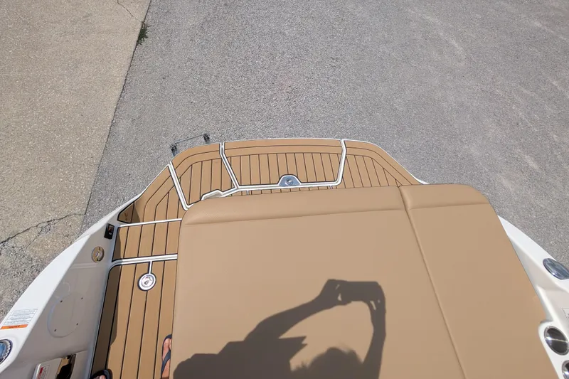 Slide: The Image of 2025 Sea Ray SDX 250 boat deck with tan seating and wood-style flooring. - 22