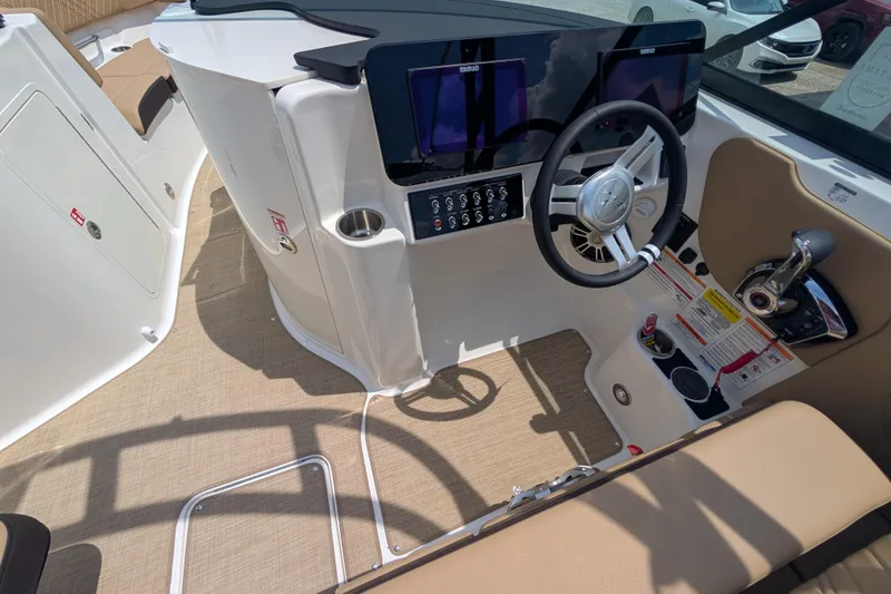 Slide: The Image of 2025 Sea Ray SDX 250 boat cockpit with modern steering and control panel. - 23