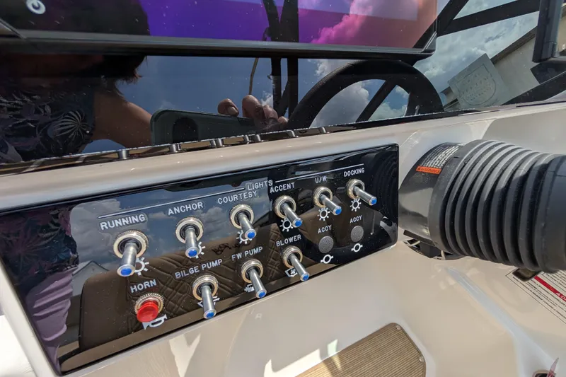 Slide: The Image of Control panel of 2025 Sea Ray SDX 250 boat with various switches and controls. - 25