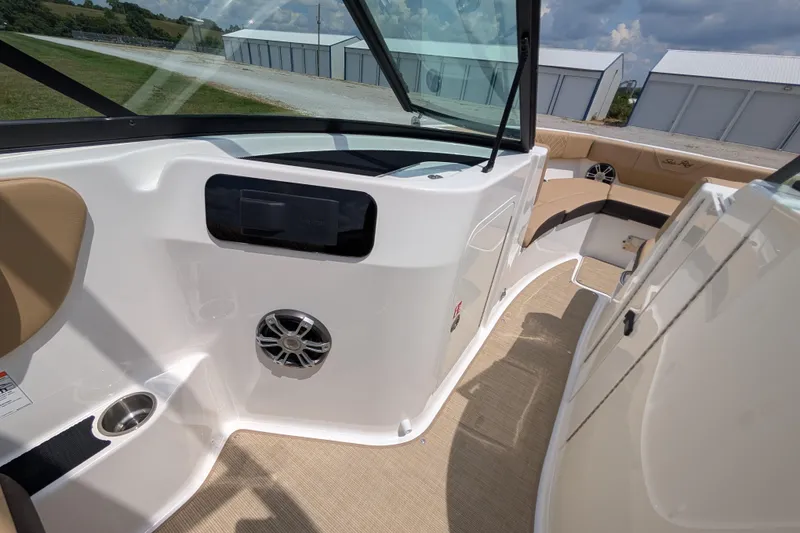 Slide: The Image of 2025 Sea Ray SDX 250 boat interior with beige seating and modern dashboard design. - 28