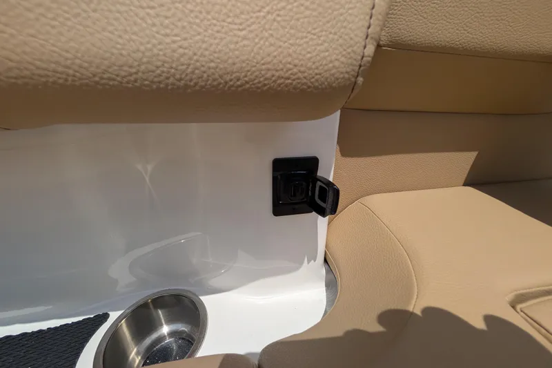 Slide: The Image of 2025 Sea Ray SDX 250 interior detail with beige seating and cup holder. - 29