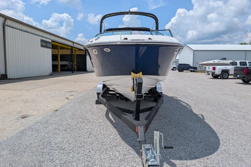 Slide: The Image of 2025 Sea Ray SDX 250 boat on trailer, parked outdoors near storage facility. - 3