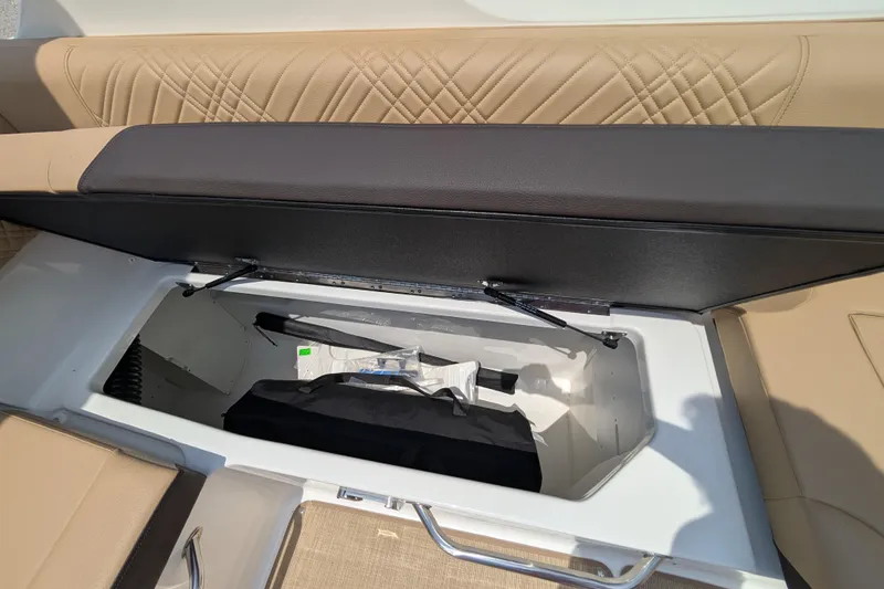Slide: The Image of 2025 Sea Ray SDX 250 boat storage compartment with open cushioned seat. - 30