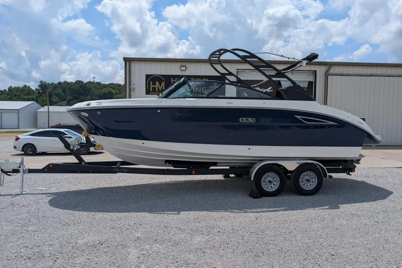 Slide: The Image of 2025 Sea Ray SDX 250 boat on trailer, parked outdoors under a cloudy sky. - 5
