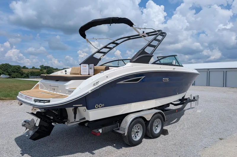 Slide: The Image of 2025 Sea Ray SDX 250 boat on trailer under a cloudy sky. - 8